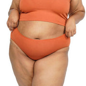 Plus-size model wearing orange hipster underwear set of 6.