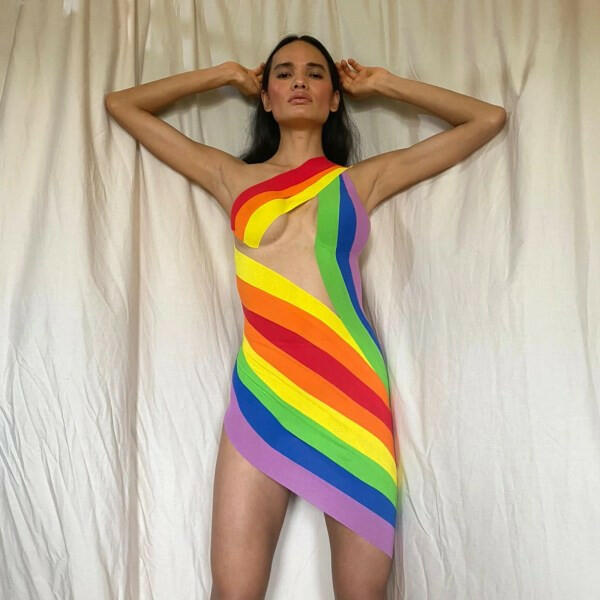 Model showcasing vibrant rainbow dress from The Pride Edit collection.