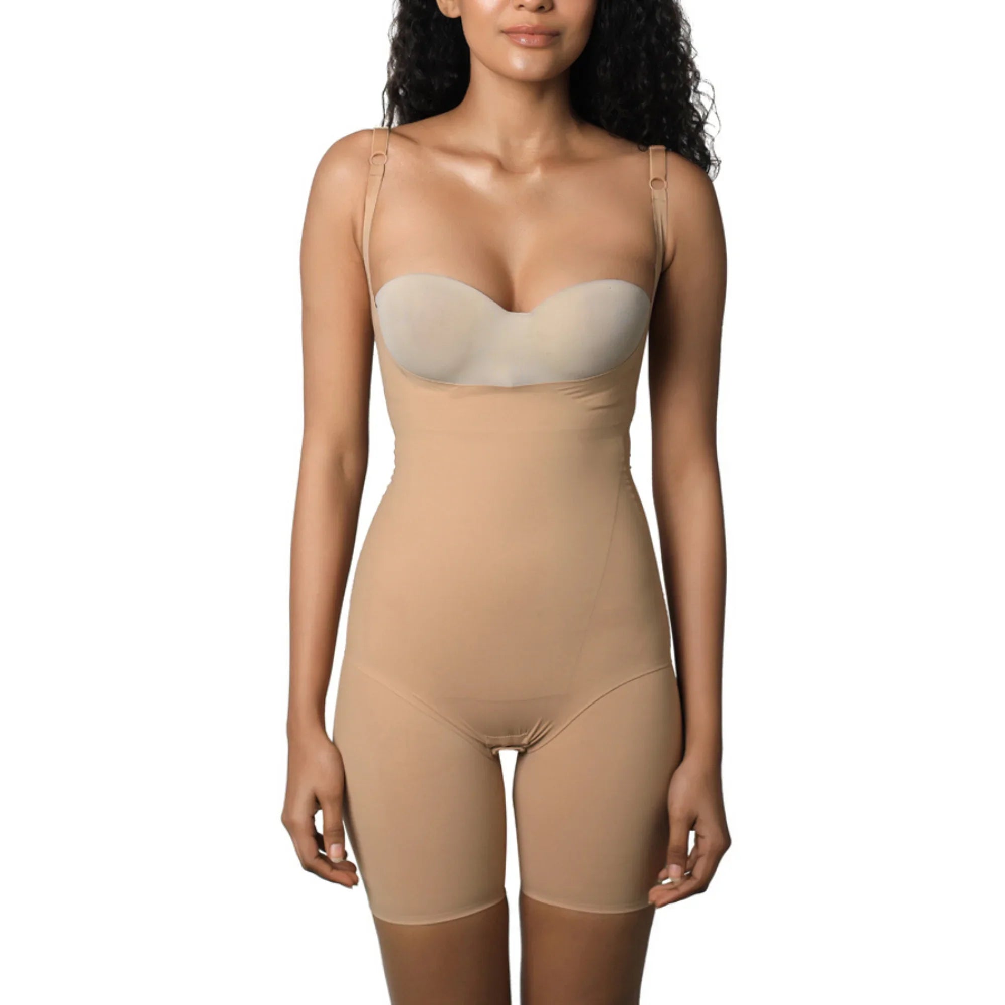 Full bodysuit in nude color worn by model with curly hair.