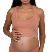 Pregnant woman wearing a crop racer tank in a set of three.