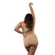 Bodysuit in nude color on model, showcasing back view and stylish design.