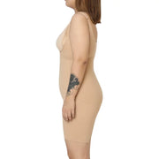 "Side view of a nude full bodysuit worn by a model."