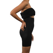 Black shapewear bodysuit displayed on a model showing side profile.